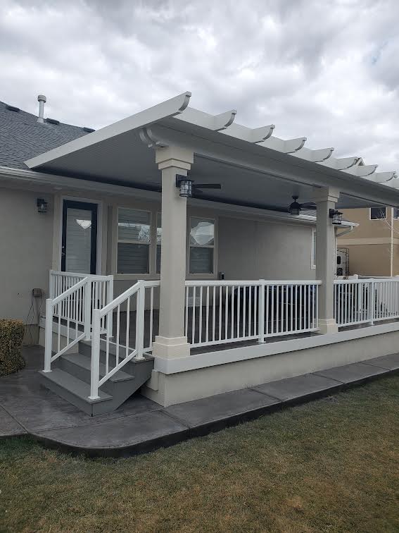 Covered patio with white pergola and railing in Utah