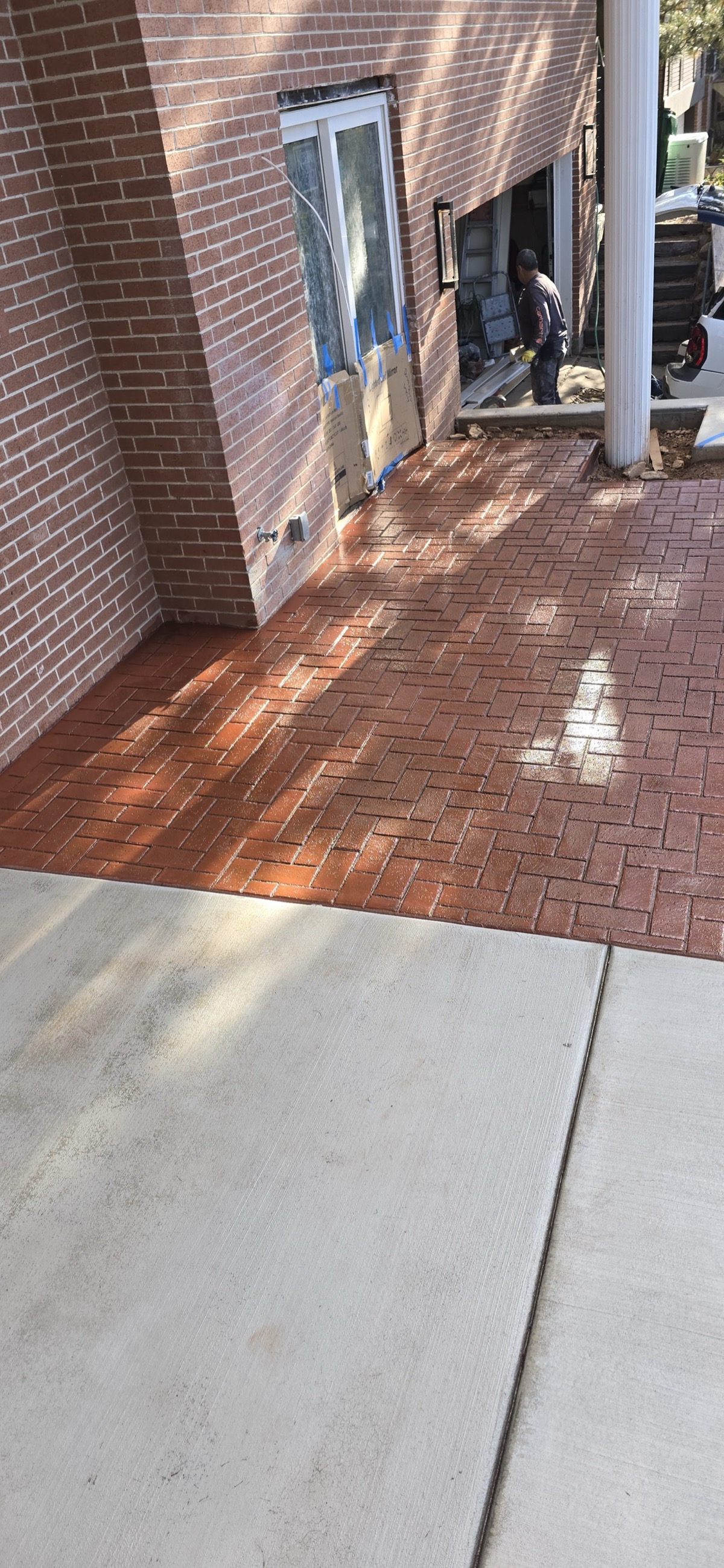 Herringbone brick pattern stamped concrete porch in Utah